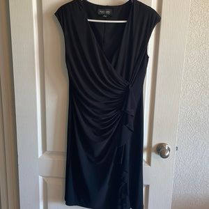 Women’s size 12 black dress. 95% polyester. Good condition.